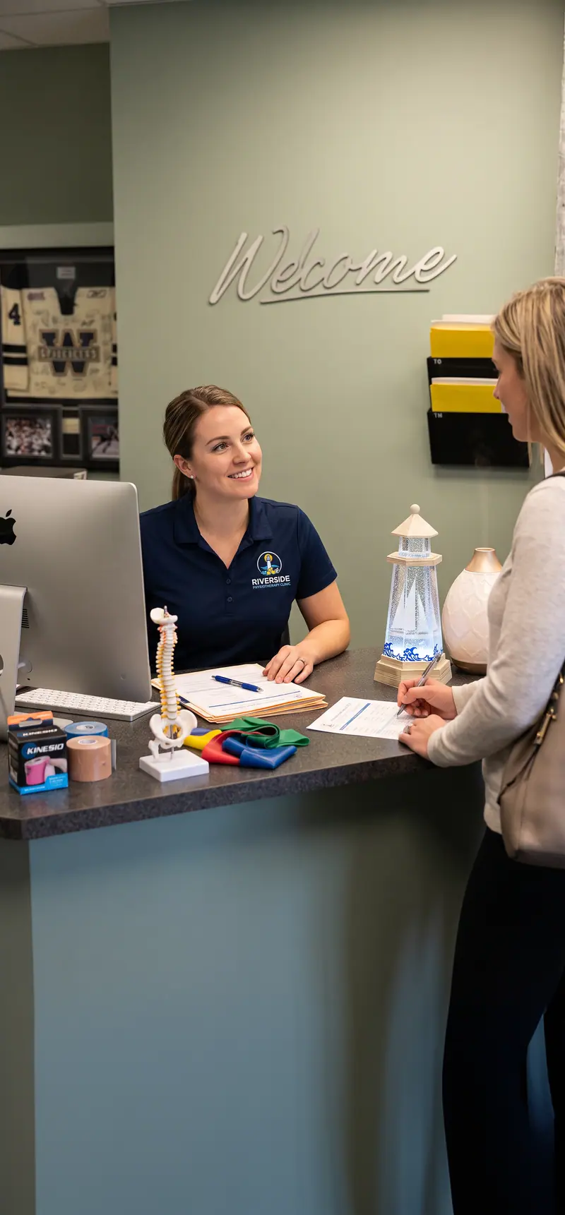 A Riverside receptionist helping a patient with forms at the front desk